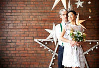 Cheerful couple near the brick wall decorated with the stars